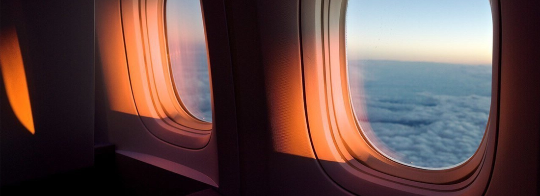 Airplane window at sunset Airplane window at sunset